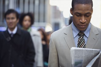 African American businessman reading newspaper