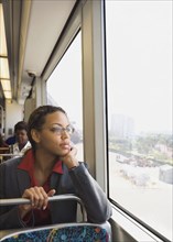 African businesswoman riding on train