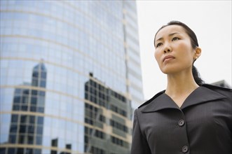 Asian businesswoman in front of high-rise
