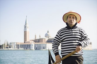 Italian gondolier with church in background