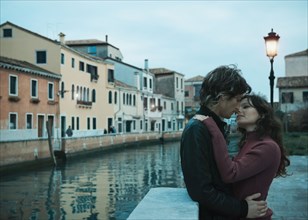 Italian couple kissing near canal