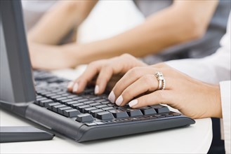 Hispanic woman typing on keyboard