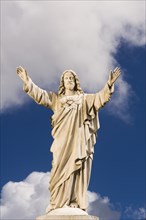 Statue of Jesus against sky