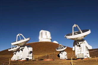 Observatory and satellite dish on hillside