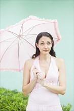 Caucasian woman holding parasol