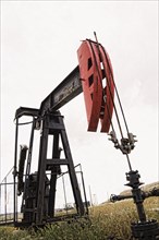 Pump working in oil field in remote landscape
