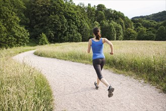 Mixed race woman running on path