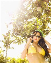Hispanic woman wearing bikini outdoors