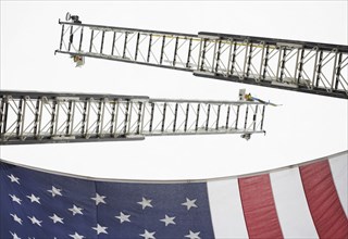 Low angle view of crane ladders and American flag