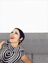Laughing woman wearing retro patterned dress