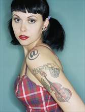 Woman with tattoos wearing retro dress