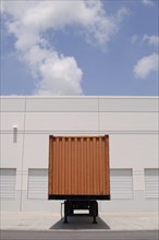 Cargo container at loading dock under blue sky