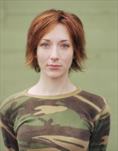 Caucasian woman wearing camouflage shirt