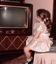 Caucasian girl watching vintage television