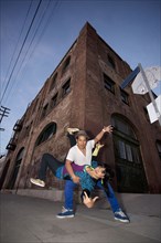 Couple breakdancing in urban area