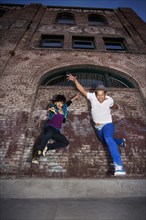 Couple breakdancing in urban area