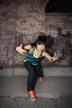 Chinese woman breakdancing in urban area