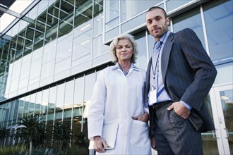 Doctor and businessman standing outdoors