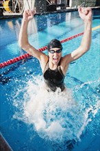 Competitive swimmer cheering in swimming pool