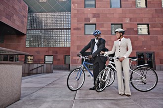 Business people in courtyard with bicycles