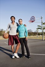 Mother and daughter playing basketball