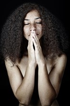 Mixed race woman praying