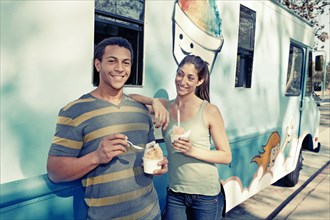Couple eating ice cream from truck