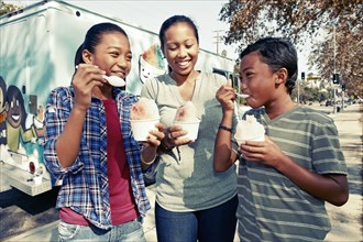 Family eating ice cream from truck