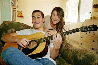 Smiling couple relaxing in living room