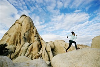 Black runner in desert landscape