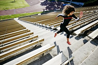 Mixed race runner training in stadium