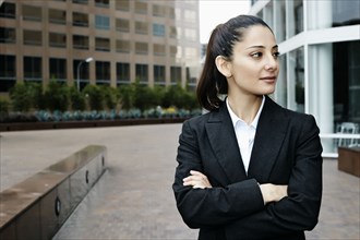 Mixed race businesswoman standing outdoors