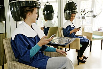 Women having hair done in salon