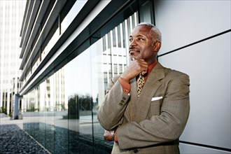 Black businessman smiling outside office