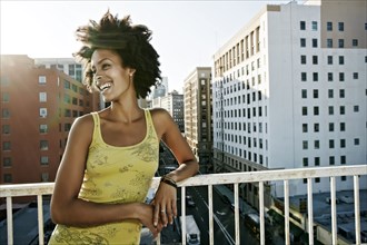 Mixed race woman on urban rooftop