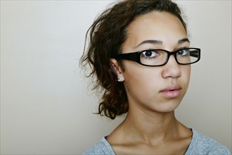 Mixed race teenage girl wearing eyeglasses