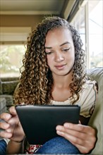 Mixed race girl using digital tablet