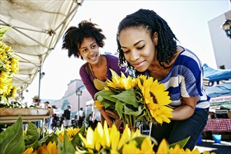 Women shopping together at flower stand