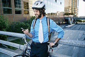 Caucasian businessman with bicycle using cell phone