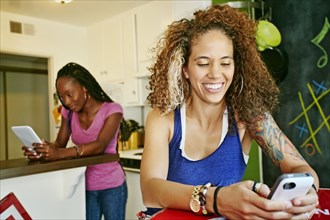 Women using technology in kitchen