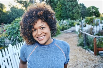 Mixed race woman smiling in garden