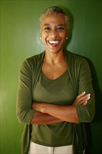 Black woman smiling with arms crossed