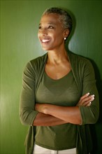 Black woman smiling with arms folded
