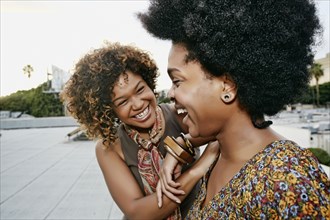 Women laughing on urban rooftop