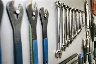 Tools arranged neatly on shop wall