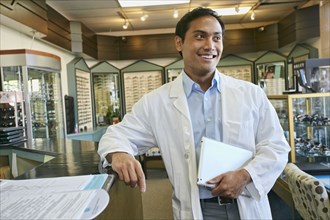Filipino optometrist smiling in office