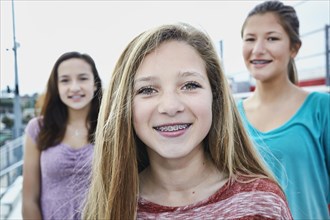 Teenage girls smiling on bleachers