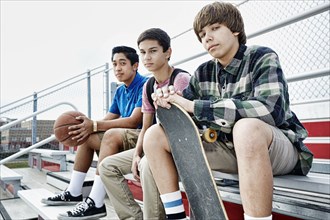 Teenage boys sitting on bleachers