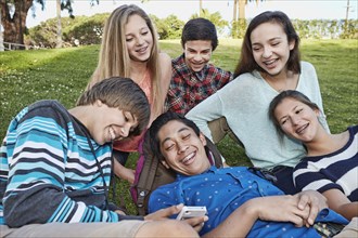 Teenagers relaxing together in grass