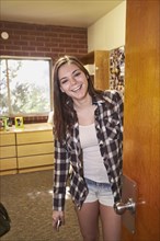 Caucasian student smiling in dorm room
